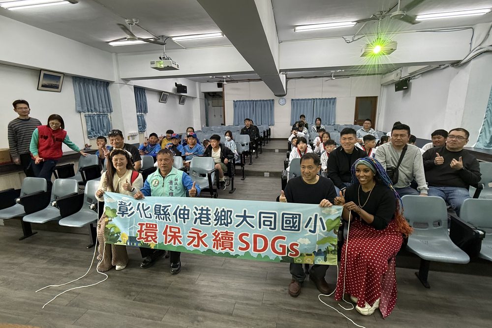 Students and a teacher holding an SDGs sustainability banner at a school event